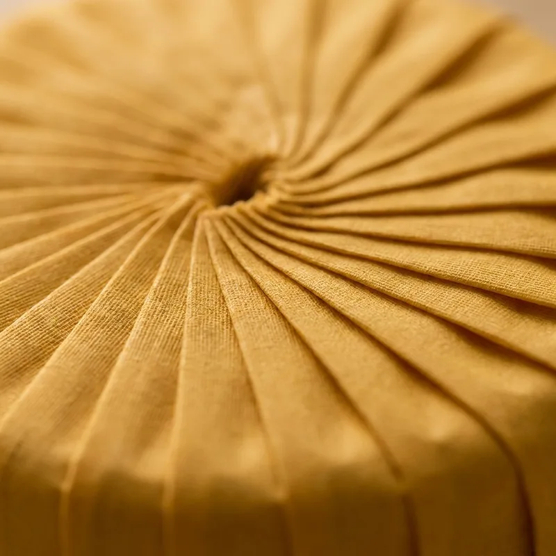 Macro detail of pleated ochre paper wrap