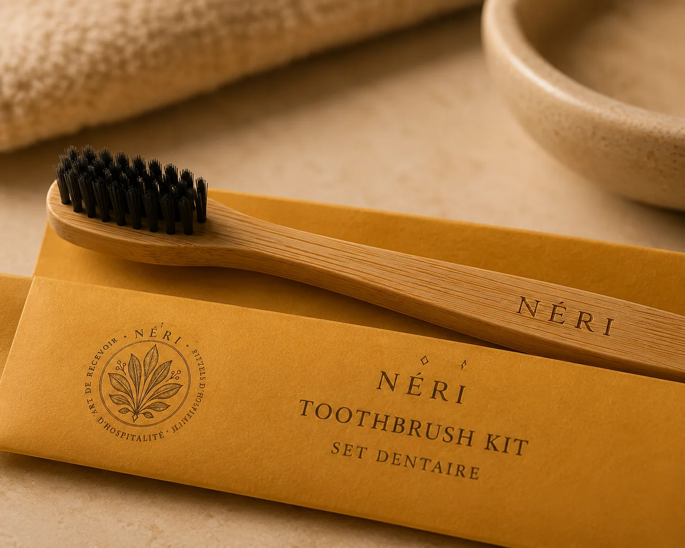 Close-up of the engraved NÉRI bamboo toothbrush resting on its kraft sleeve
